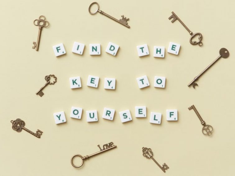 Creative arrangement of vintage keys and motivational text 'Find the key to yourself'.
